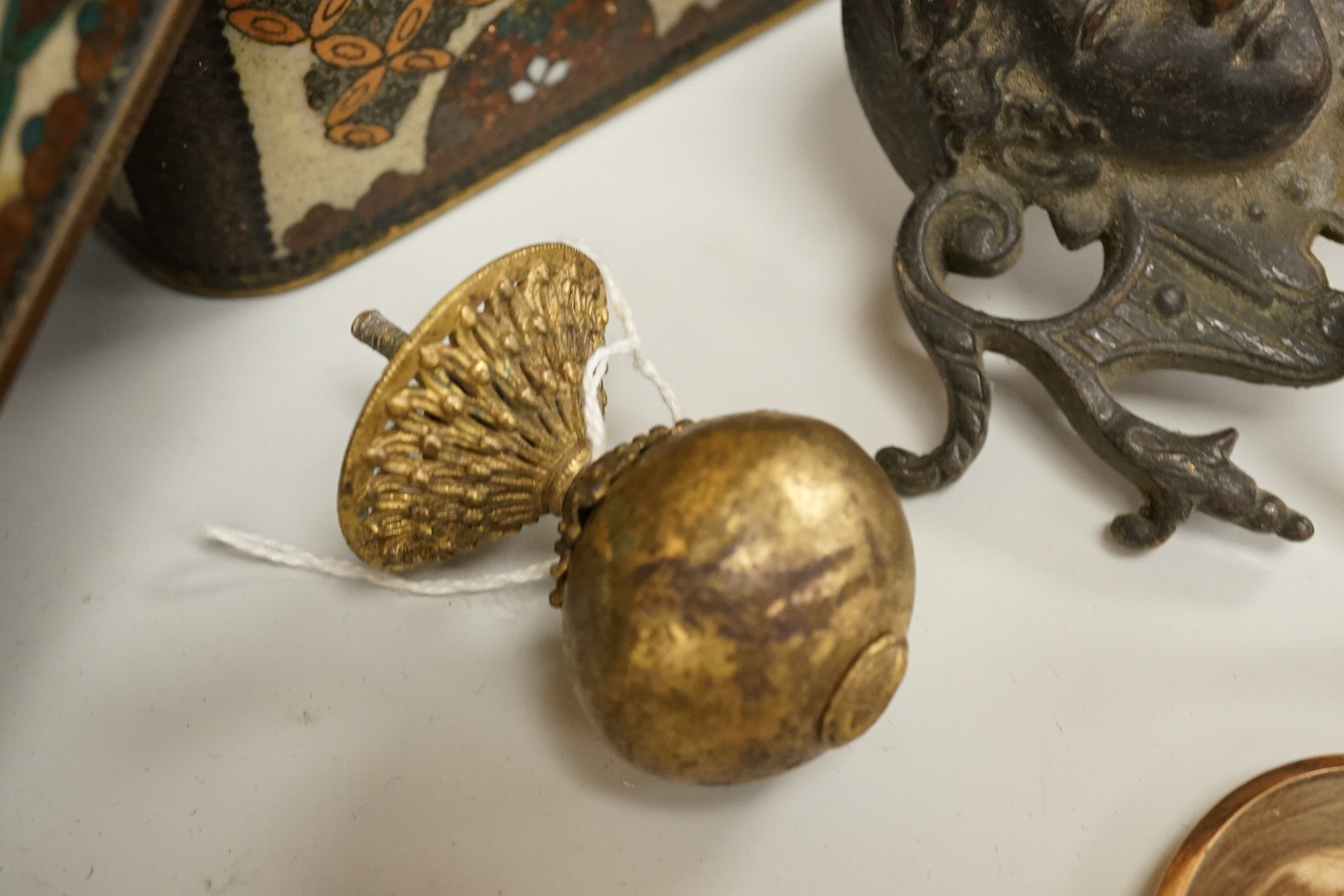 A large cloisonné enamel box containing a cast mask handle, an oval hair pendant, coins and medals, etc.